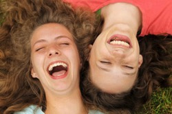 Girls laughing in grass 350